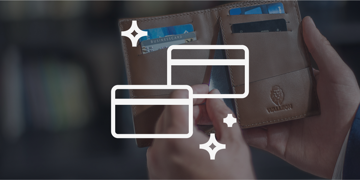 Shot of a leather wallet with a hand pulling out a card. There is a white icon illustration of two credit cards on top.